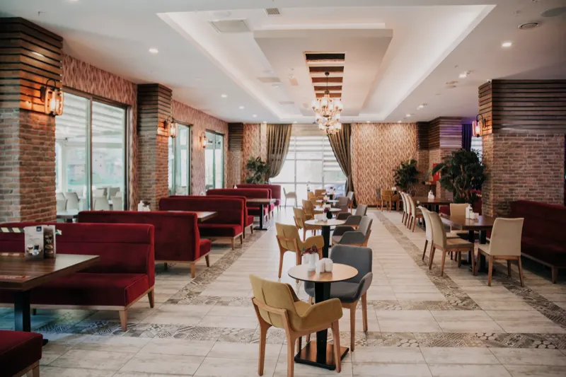 A’La Carte Restaurant: brick columns, burgundy banquettes and chandeliers